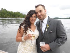 Stephanie and Jordan on the pier with drinks.