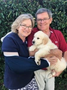 Rick and Sue holding their new puppy, Ranger.