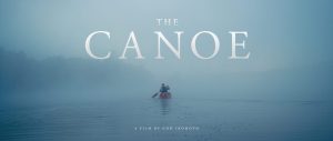 Person in canoe in fog. Text: The Canoe
