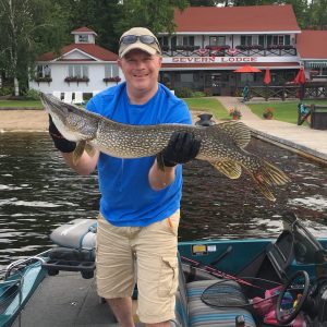 Man holding a northern pike caught from Gloucester Pool.