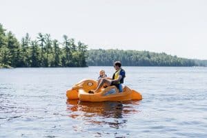 Parent and child on banana paddle boat.