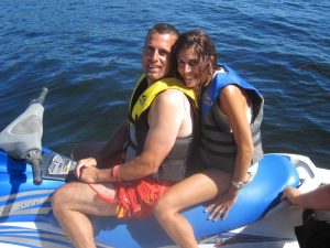A romantic couple enjoys their Ontario getaway by riding a jet ski.