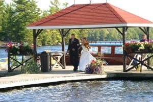 Bride and Groom walking down pier.