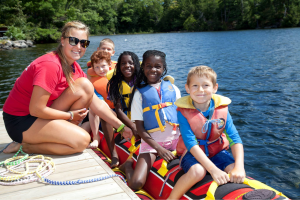 Severn Lodge team member with kids on banana boat.