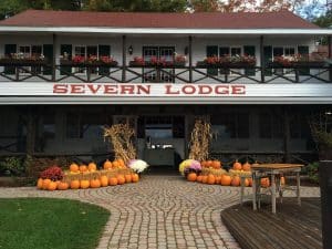 Severn Lodge main lodge exterior with pumpkins and corn stalks.