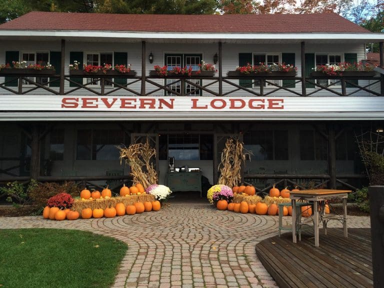 Severn Lodge main lodge exterior with pumpkins and corn stalks.