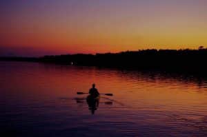 Photo of a Person on a Kayak at Dawn, Headed Out onto the Lake for Some Bass Fishing in Ontario.