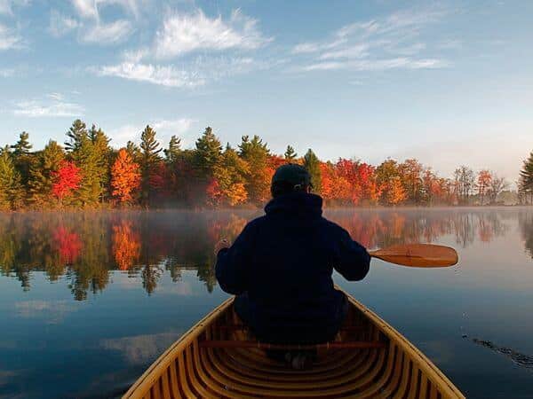 Photo of a Man Paddling on Gloucester Pool, One of the Best Fall Getaways in Ontario.