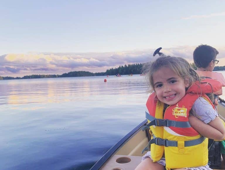 Photo of a Young, Happy Girl on a Canoe at Severn, One of the Best Ontario Getaways in Spring.