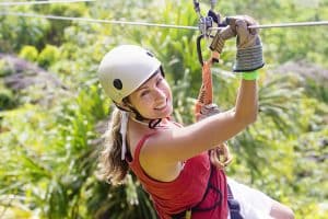 A young outdoor enthusiast smiles as she enjoys ziplining in Ontario.