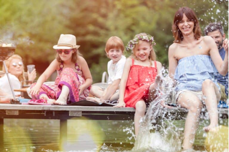 A group of cousins splash in Gloucester Pool during their Ontario family reunion.