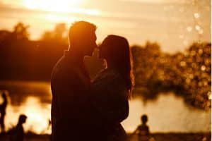 A romantic couple share a warm embrace during a getaway to Severn Lodge in Muskoka, Ontario.