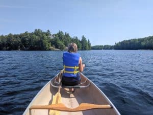 A canoer explores Six Mile Lake Provincial Park by water.