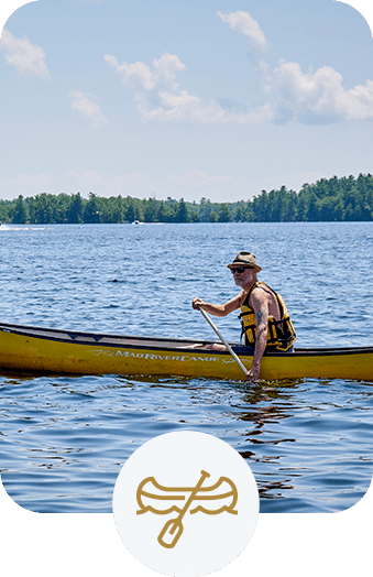 Man rowing a canoe on a beautiful lake