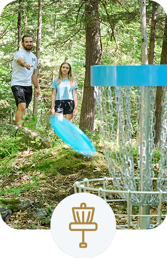 Friends playing disc golf in the forest