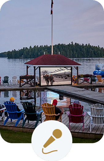 Friends watching a movie being projected on a dock