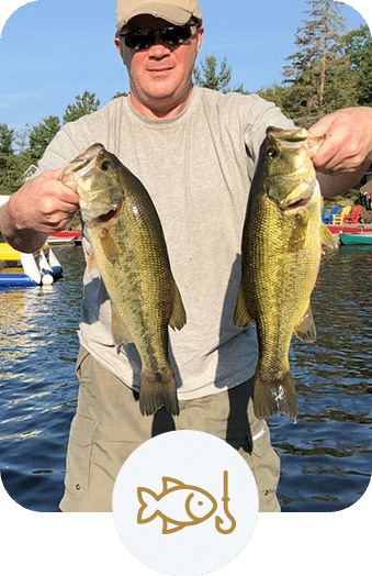 Man showing off 2 large fish he caught