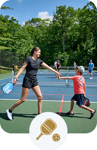 Family playing a game of pickleball