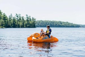 Muskoka Spring: A father and daughter enjoy a pedal boat ride during their Muskoka Getaway at Severn Lodge.