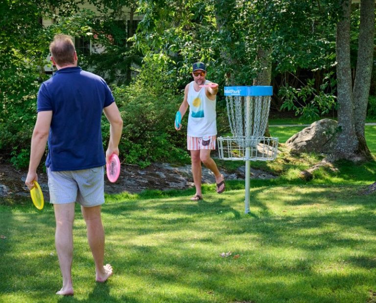 How to Play Disc Golf: A pair of disc golfers take shots at the Gloucester Pool Course.