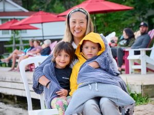 Spring Break Ontario: A young woman holding her children near a bonfire at Severn Lodge.