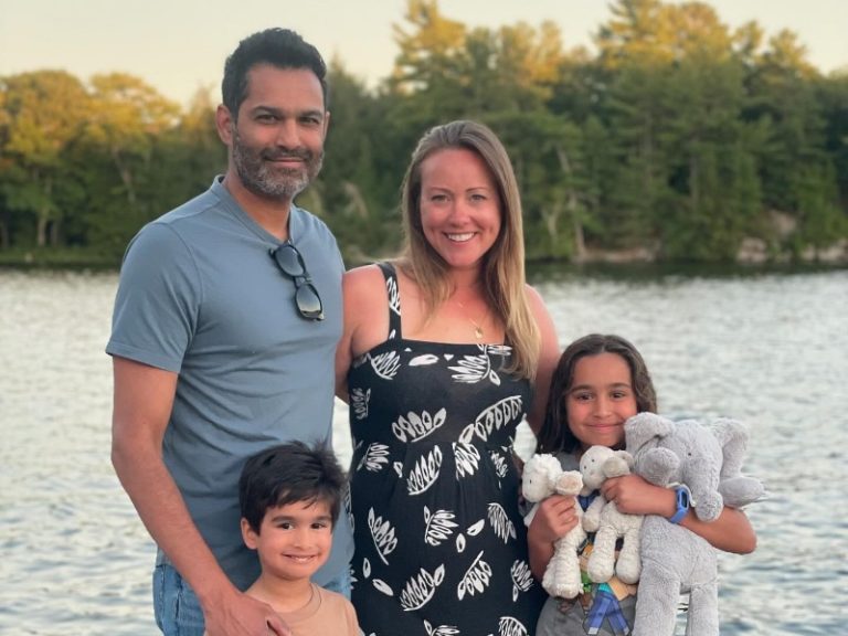 Toronto to Muskoka: A young family smiles while standing on the dock overlooking Gloucester Pool.