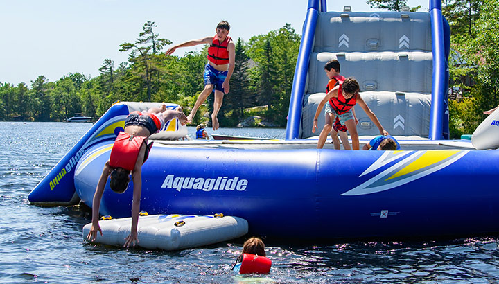 Families enjoying beach and water sports at Severn Lodge Muskoka