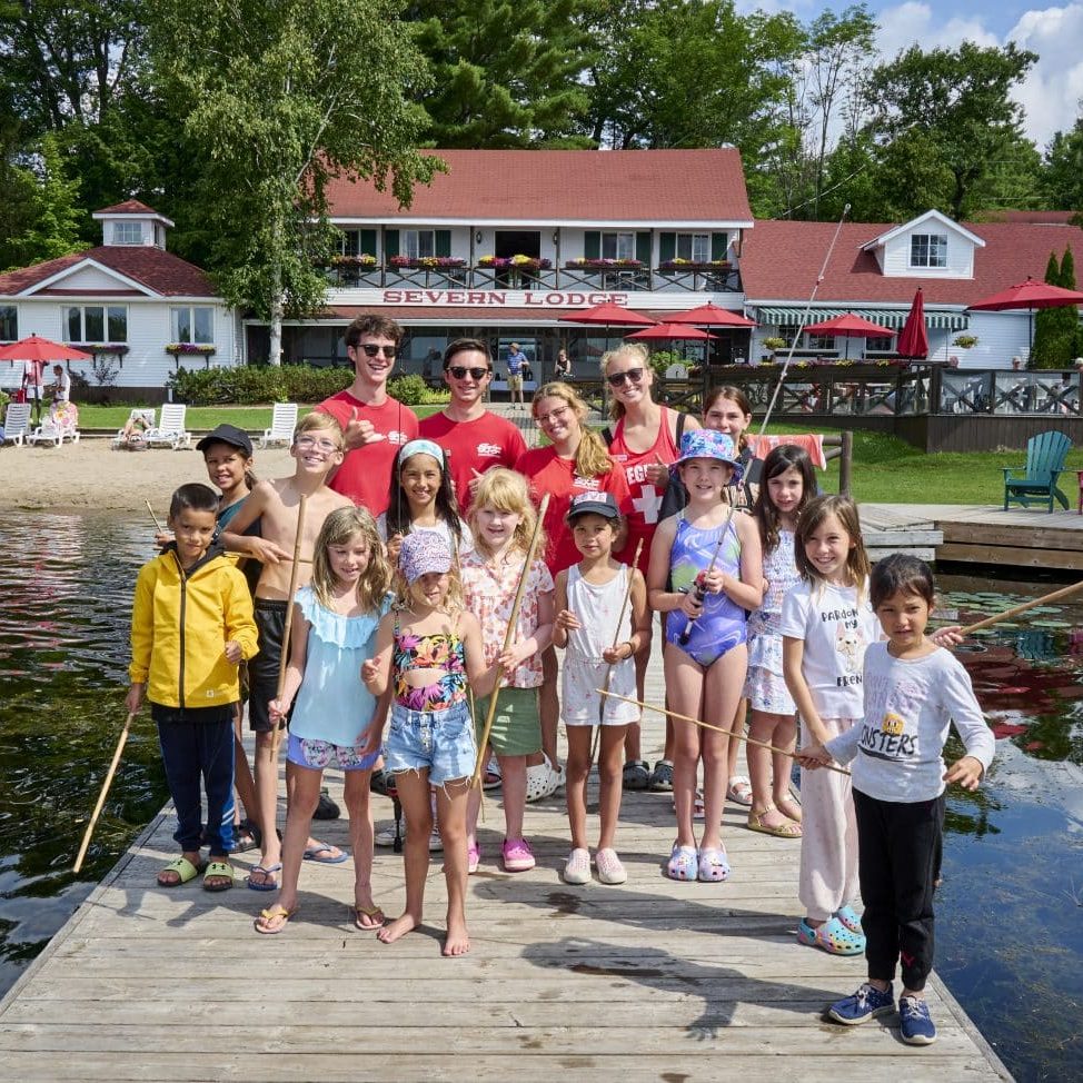 Group of kids on a dock about to go fishing