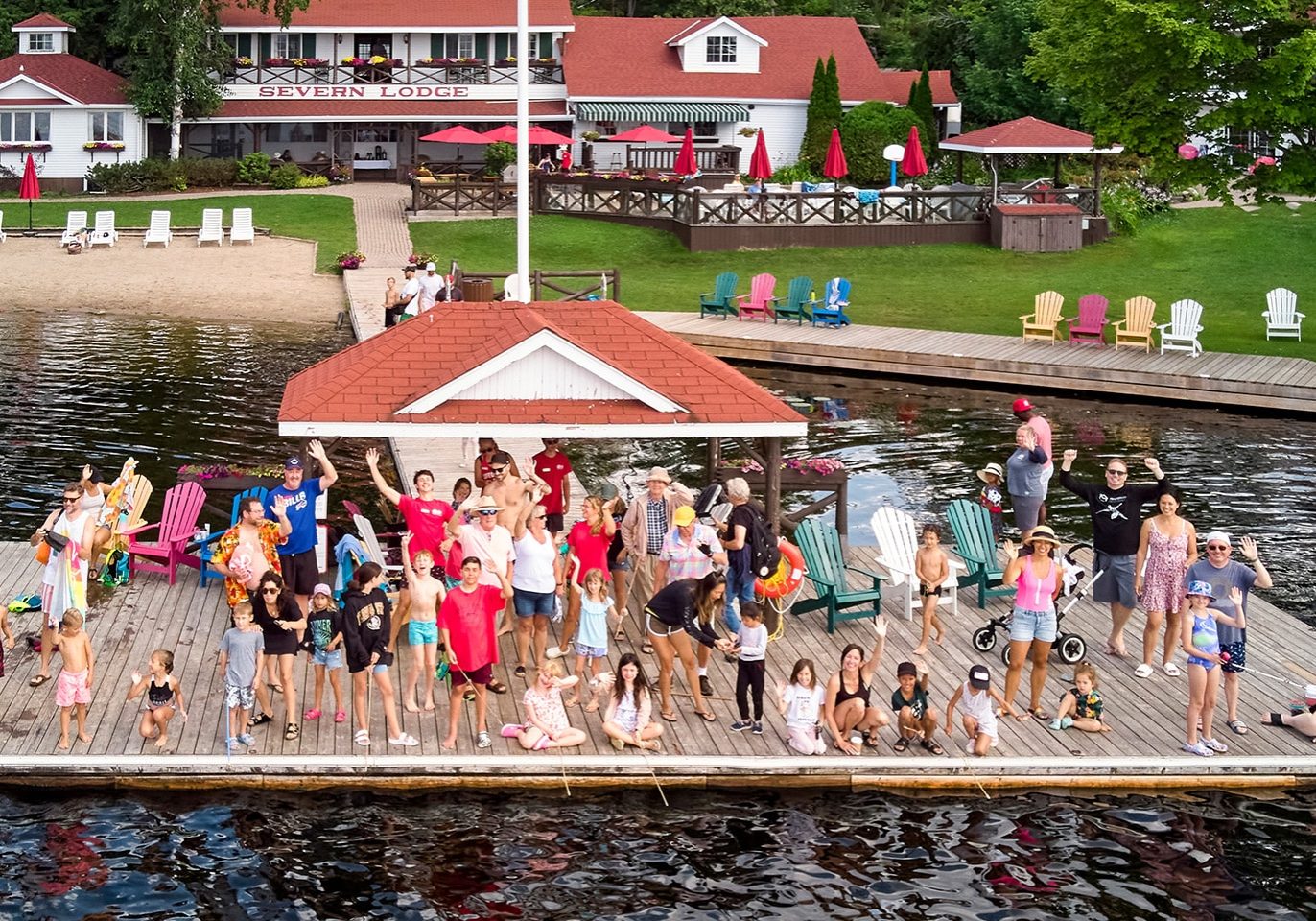 A group of people waving on a dock