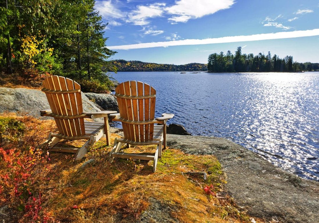 Muskoka chairs overlooking a lake
